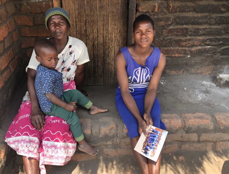 Calicious (R) her mother Yasinta (L) with Colings at their home in Chimpakati village